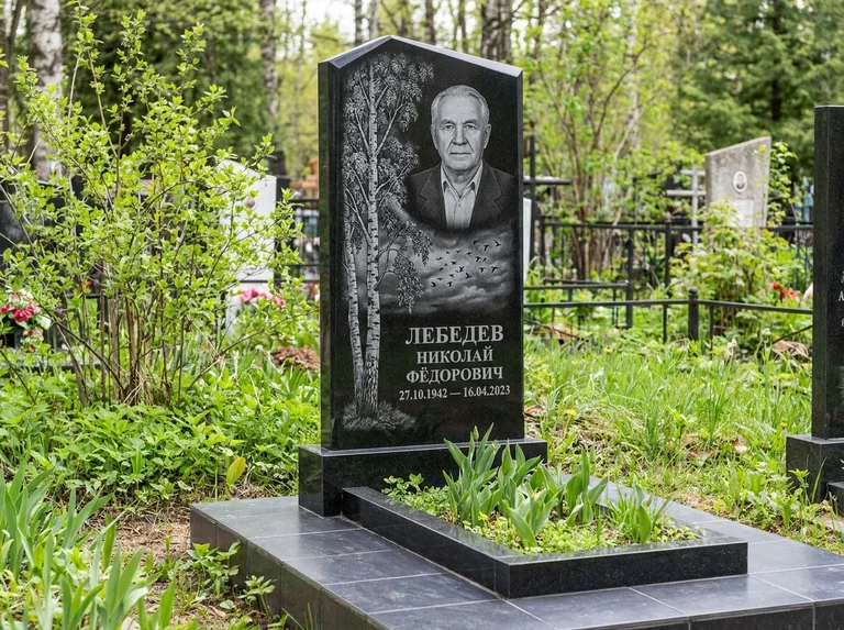 Памятник с гравировкой берёзы: вертикальная стела со скошенным верхом — берёза и стая птиц в небе, гранитный цоколь с тёмной плиткой, работа «Лебедев» в Казани